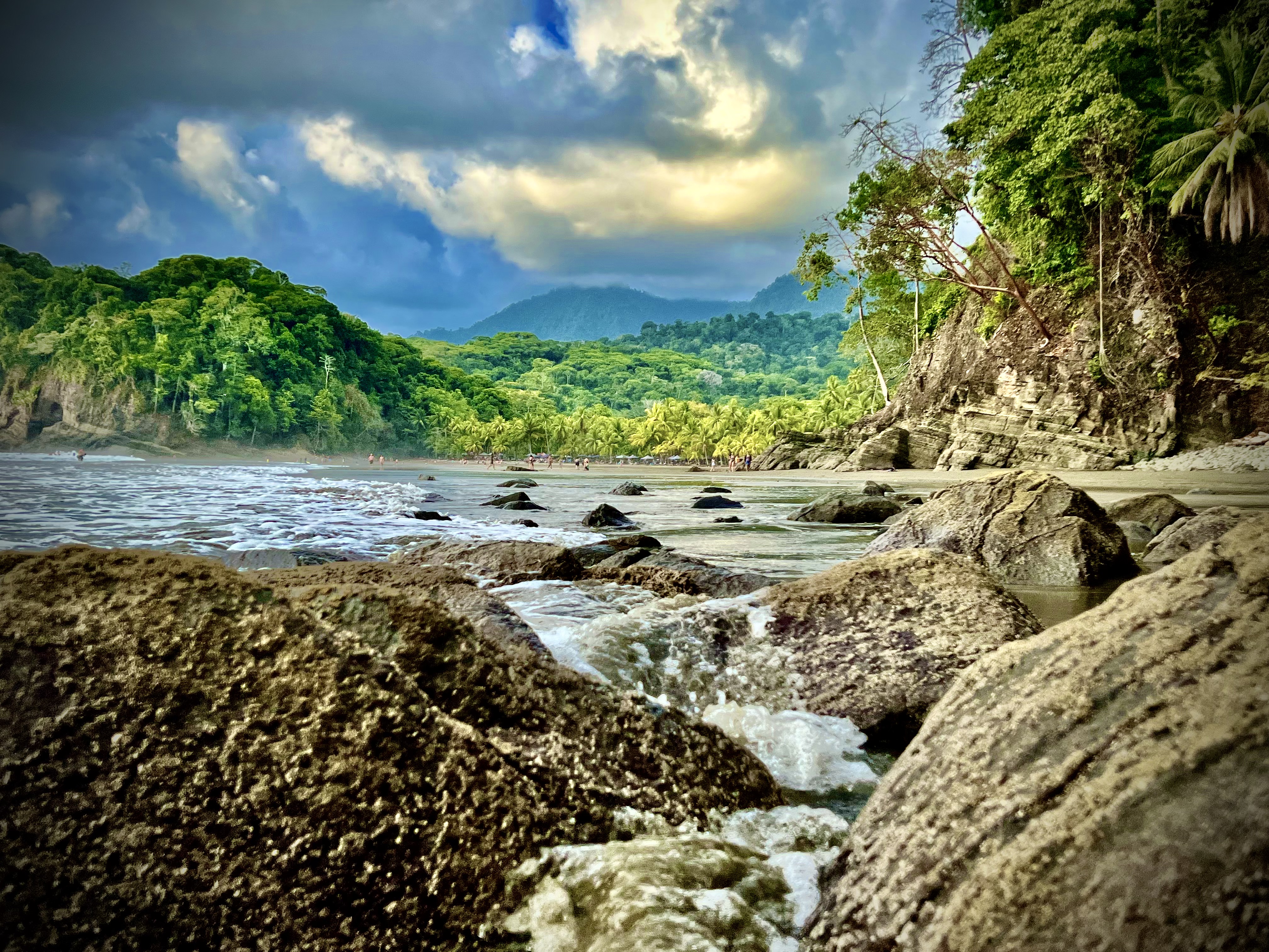 Rocky shoreline and tropical rainforest at Playa Ventanas in Costa Rica