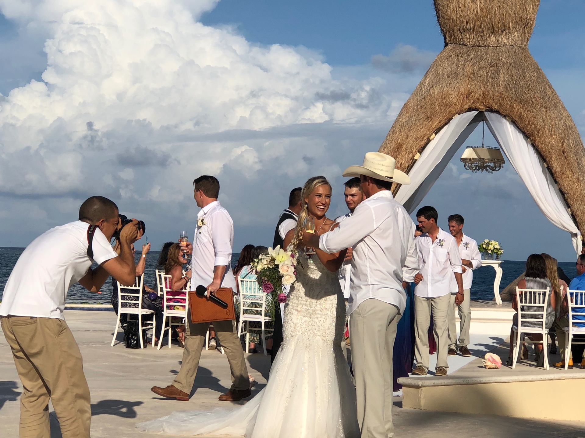 Photographer capturing a candid moment between the bride and groom at their destination wedding