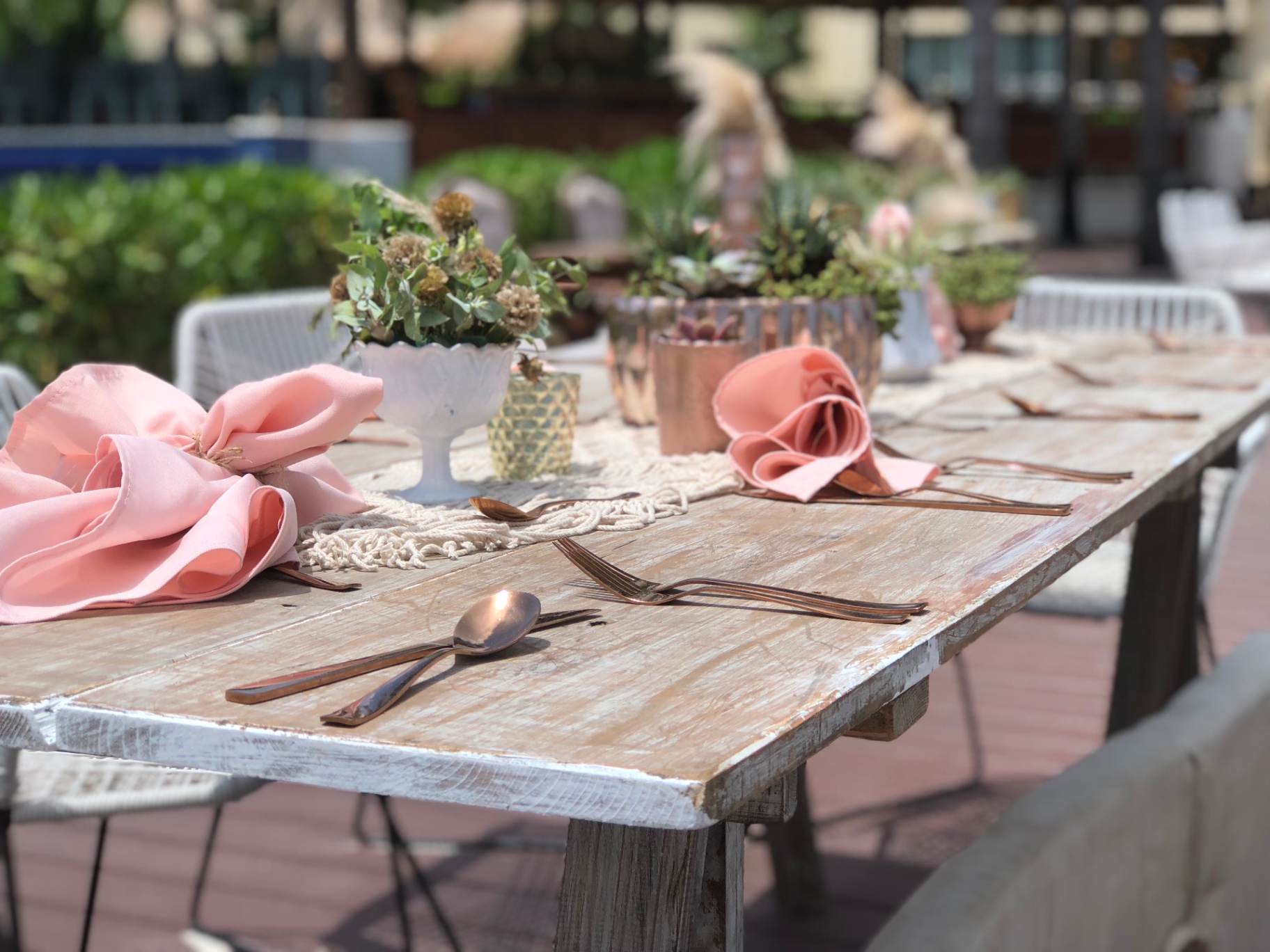 Wedding-day hair and makeup station with brushes, palettes, and a mirror at a destination wedding resort — the kind of behind-the-scenes coordination a travel agent quietly handles alongside your invitation timeline