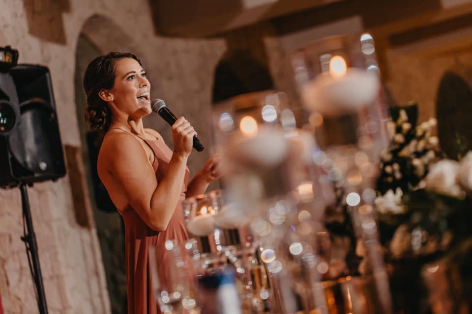 Wedding guest giving a toast at a destination wedding reception