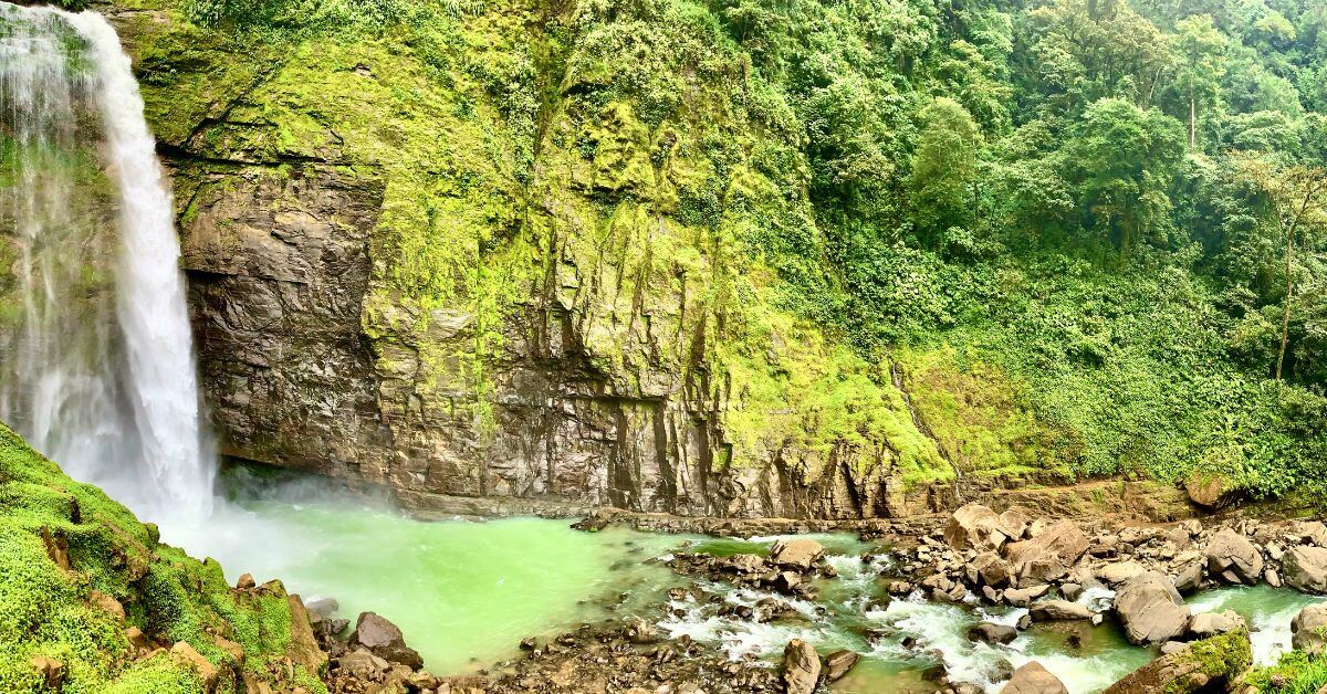 Lush Costa Rica waterfall surrounded by rainforest and tropical greenery