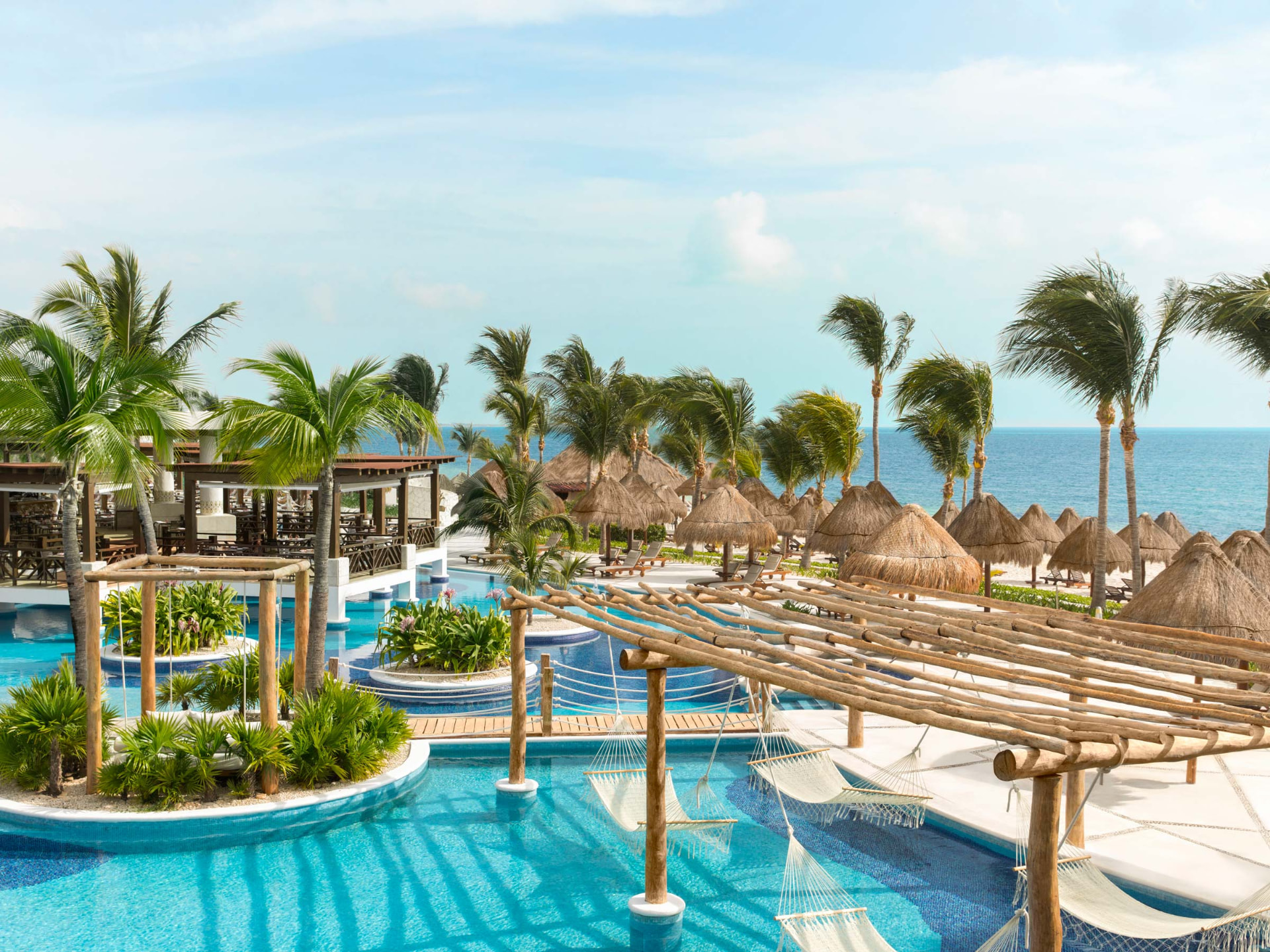 Aerial view of Excellence Playa Mujeres, an adults-only all-inclusive resort with pools, palms, and a wide Caribbean beach