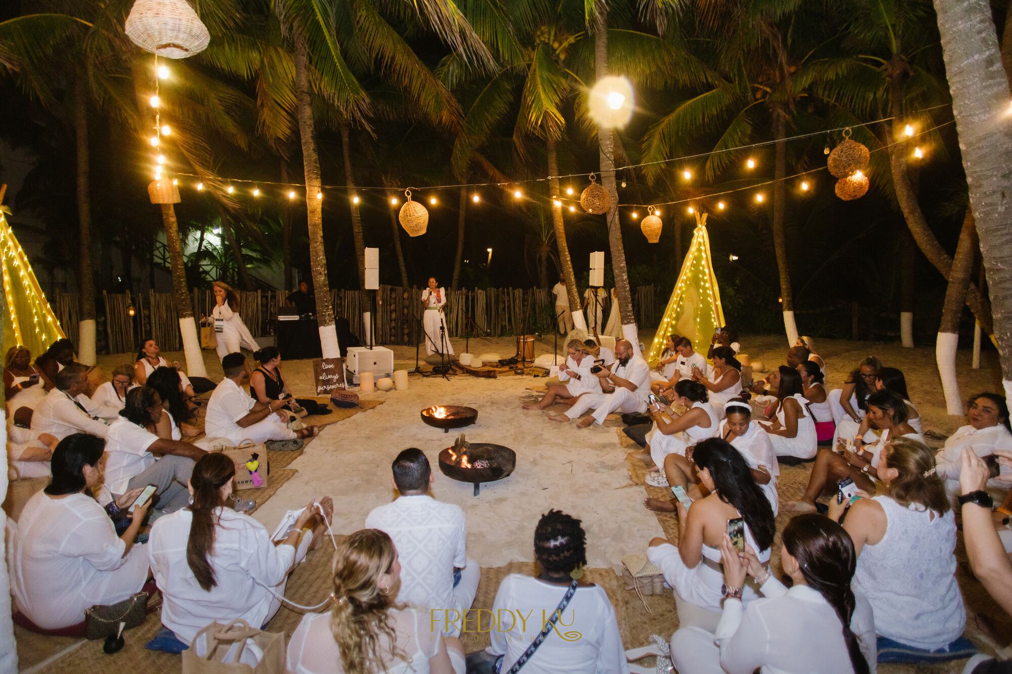 Adults-only oceanfront terrace reception with fountain and lounge seating at a destination wedding