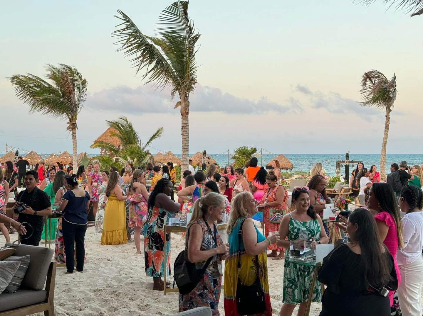 Wedding guests laughing together and celebrating at a destination wedding reception — the version of the guest list that shows up when a couple holds the vision, communicates clearly, and stops trying to convince the guests who never intended to travel in the first place