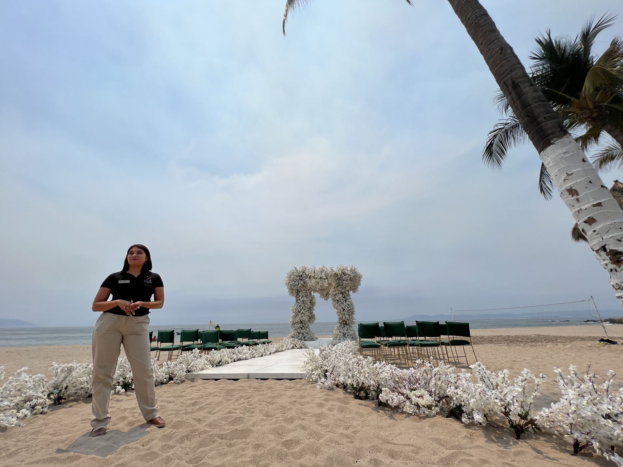 Covered fountain-terrace wedding ceremony setup with white draped chairs — a decor style that reads beautifully whether the day stays dry or moves under cover