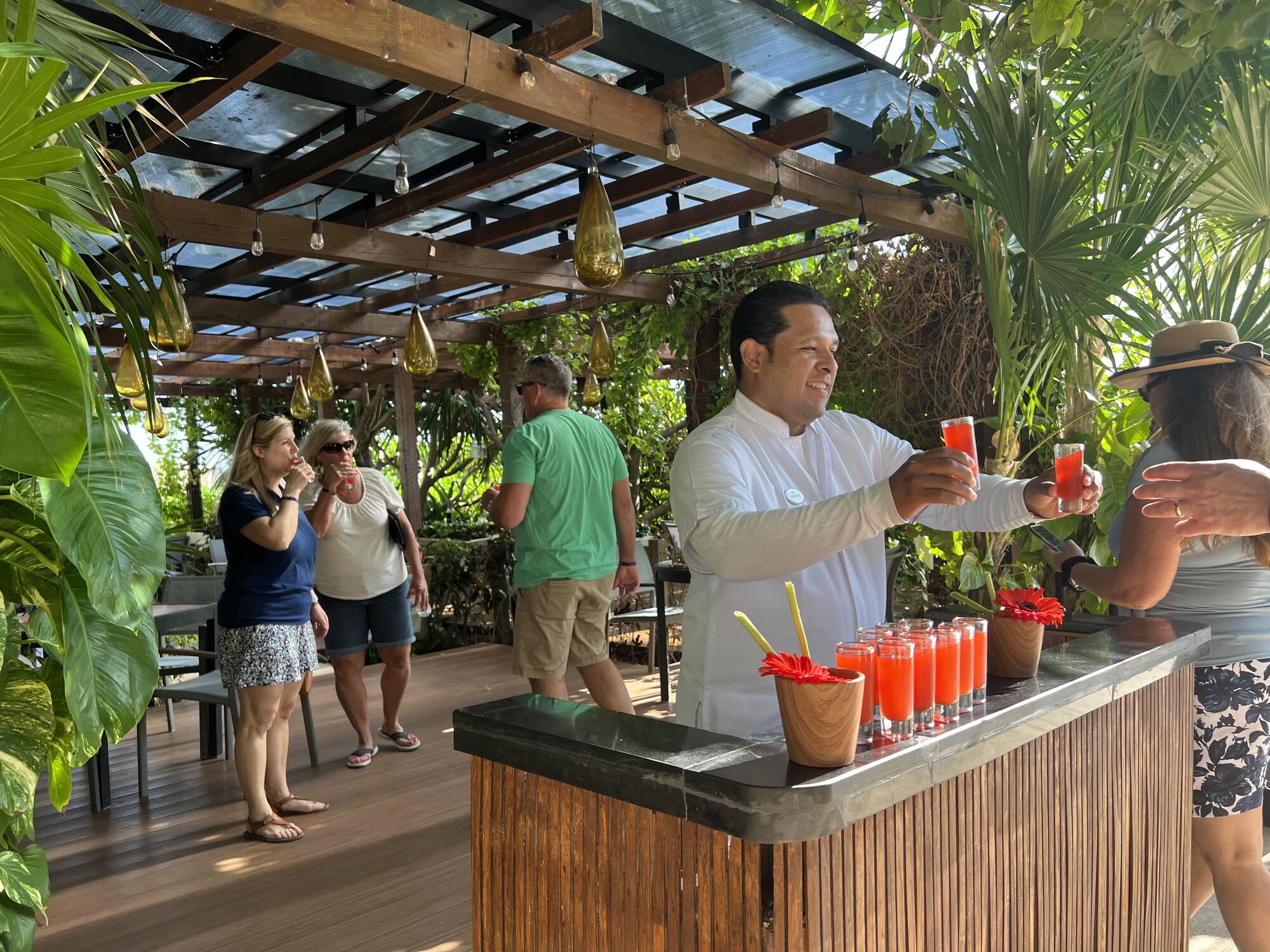 A guest raising a glass and giving a toast at a destination wedding reception — the version of the guest relationship couples are working toward when they hold their nerve through the early pushback and keep the vision they set out to celebrate