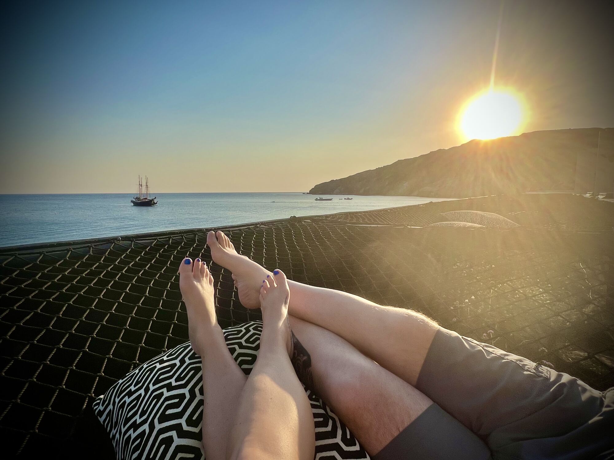 Outdoor couple's hot-stone massage at a tropical resort spa — a signature honeymoon-fund experience guests love gifting to newlyweds