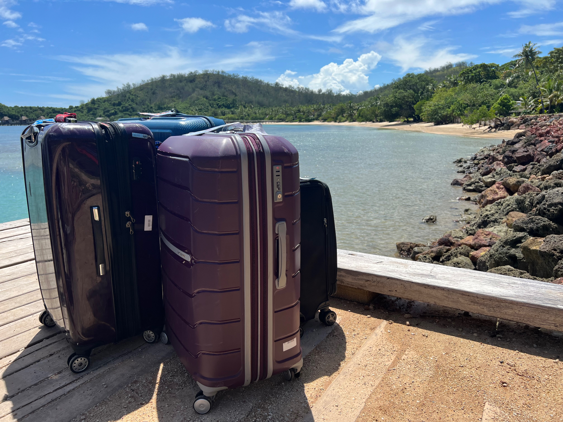 Luggage packed for a destination wedding trip requiring travel protection.