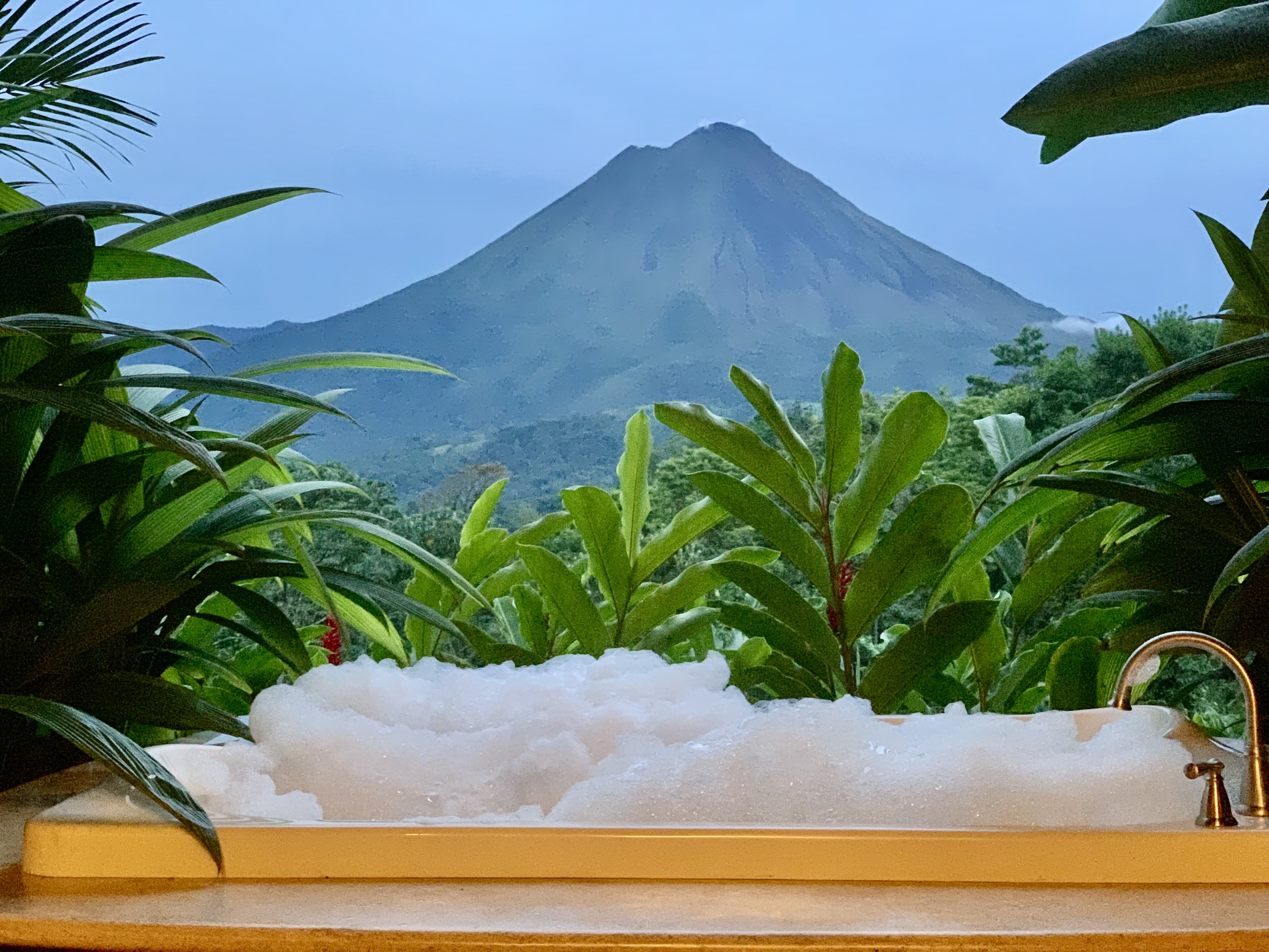Arenal Volcano view from an outdoor bathtub at a hotel in La Fortuna, Costa Rica