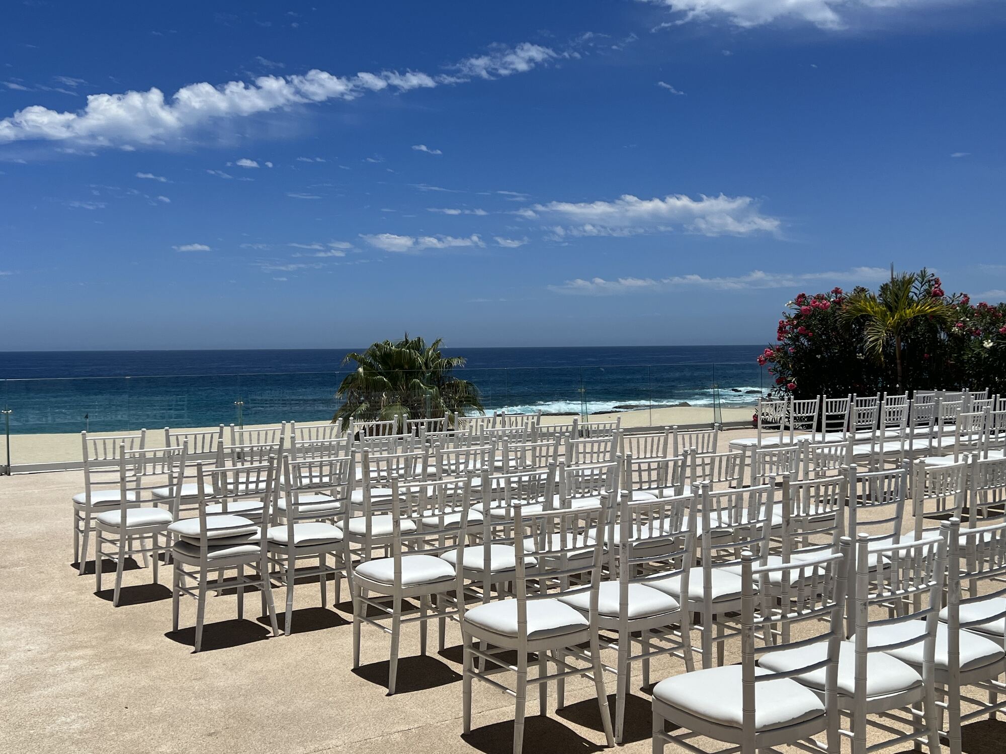 Intimate garden reception setup with romantic string lights and cross-back chairs — the kind of curated setting that pushes couples toward a venue-first destination wedding approach