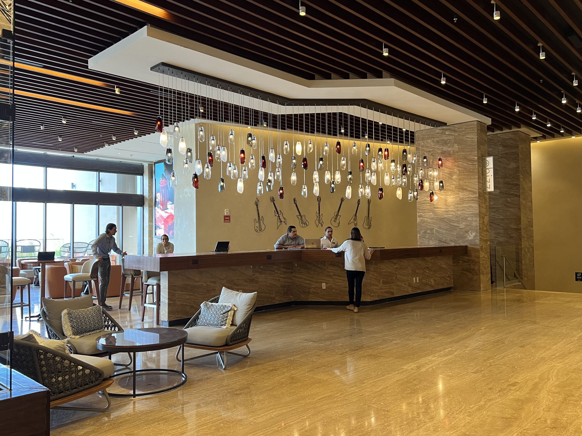 Wedding group checking in at a Caribbean resort lobby — the moment where a well-negotiated room block quietly delivers upgrades, perks, and better rates than the same guests would have gotten booking direct
