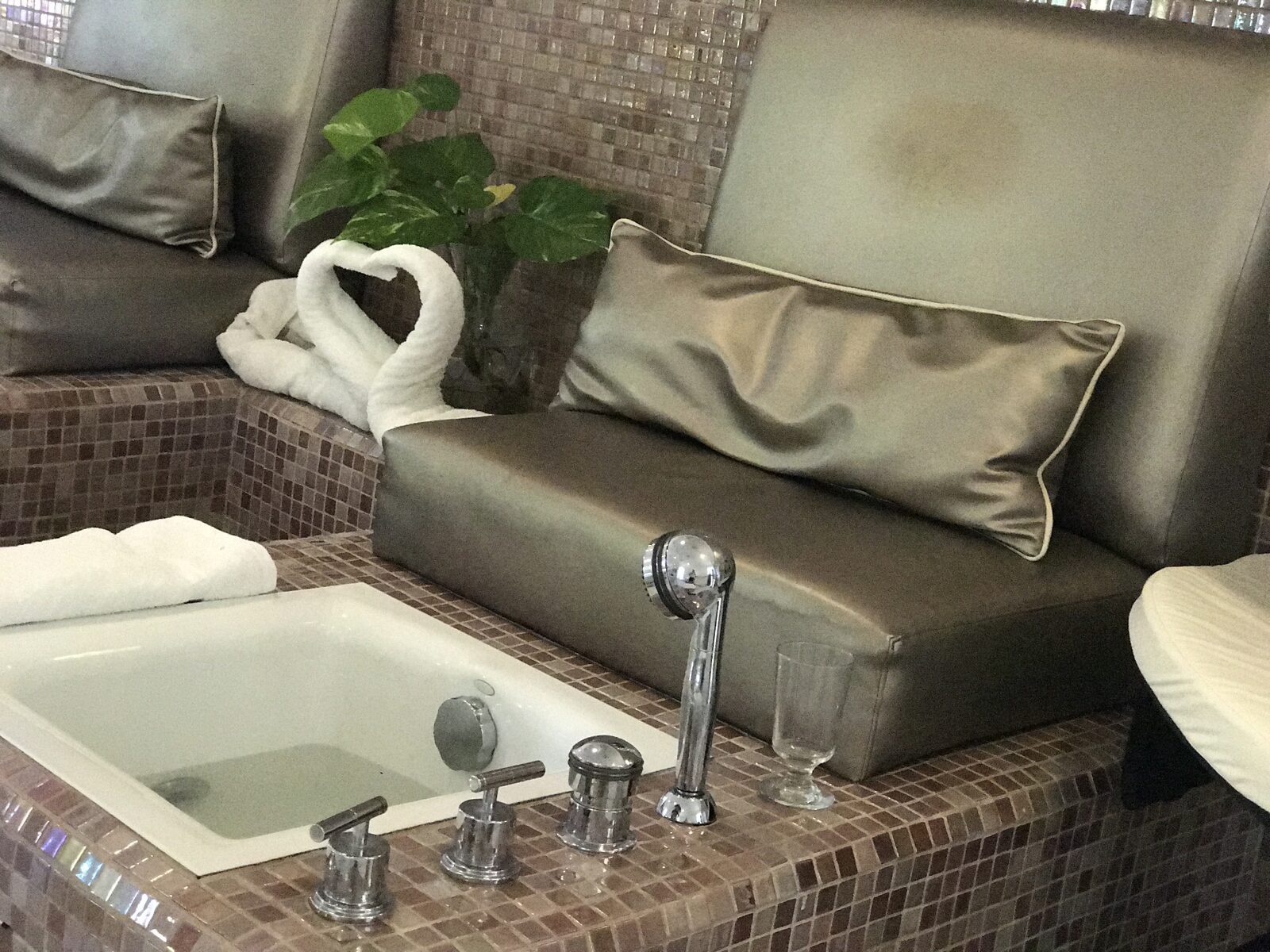 A luxurious resort spa pedicure tub with a swan-folded towel, the kind of quiet pre-wedding moment couples should build into the day