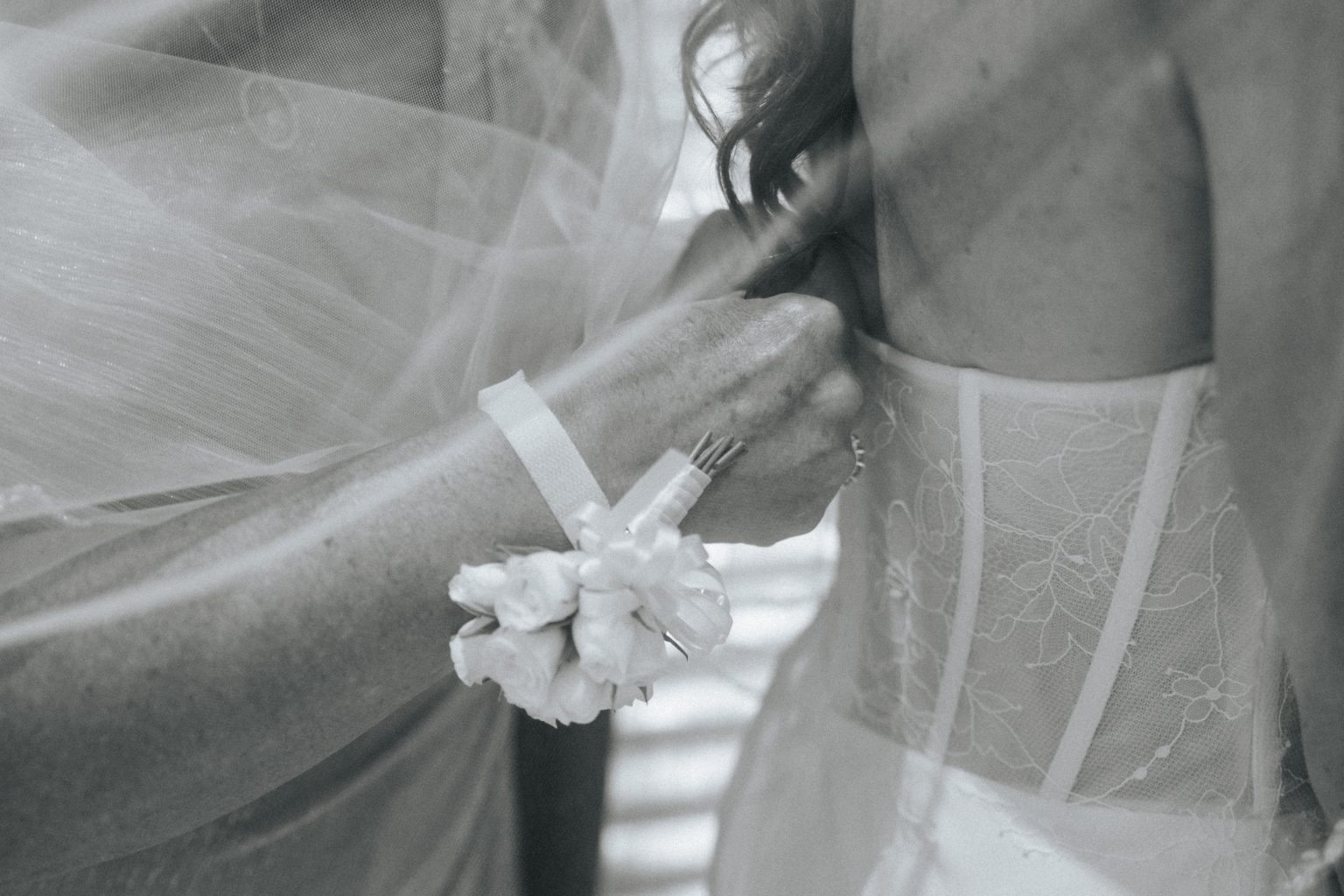 Close-up of the groom holding the bride's hand beneath her veil, detail shot from a Secrets Playa Blanca wedding