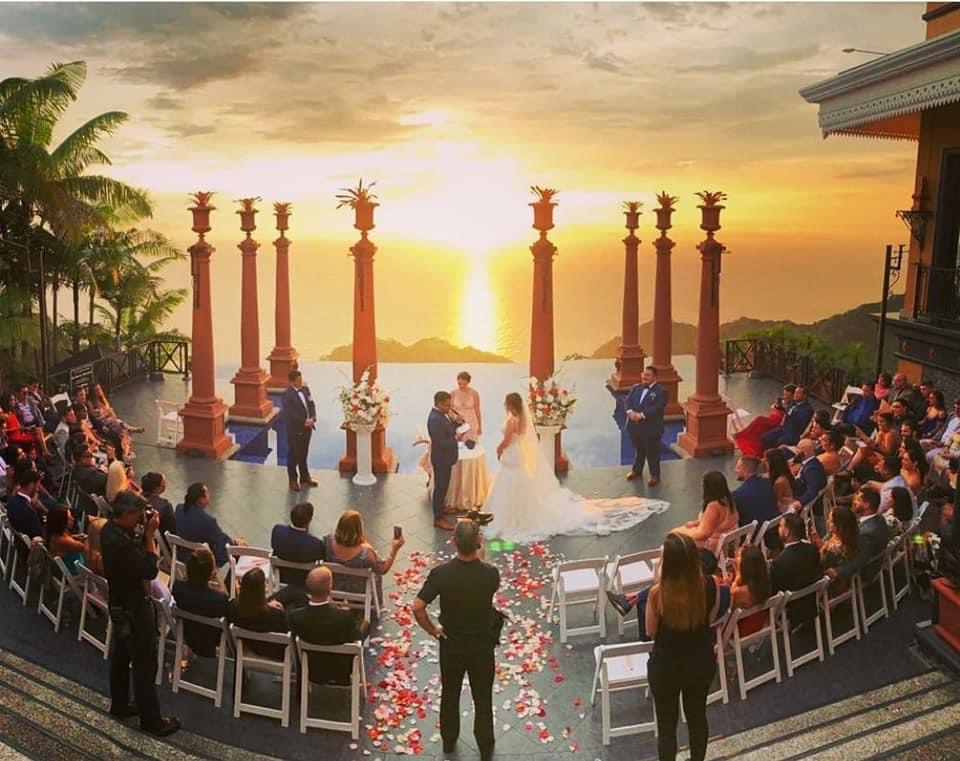 Sunset destination wedding ceremony overlooking the ocean