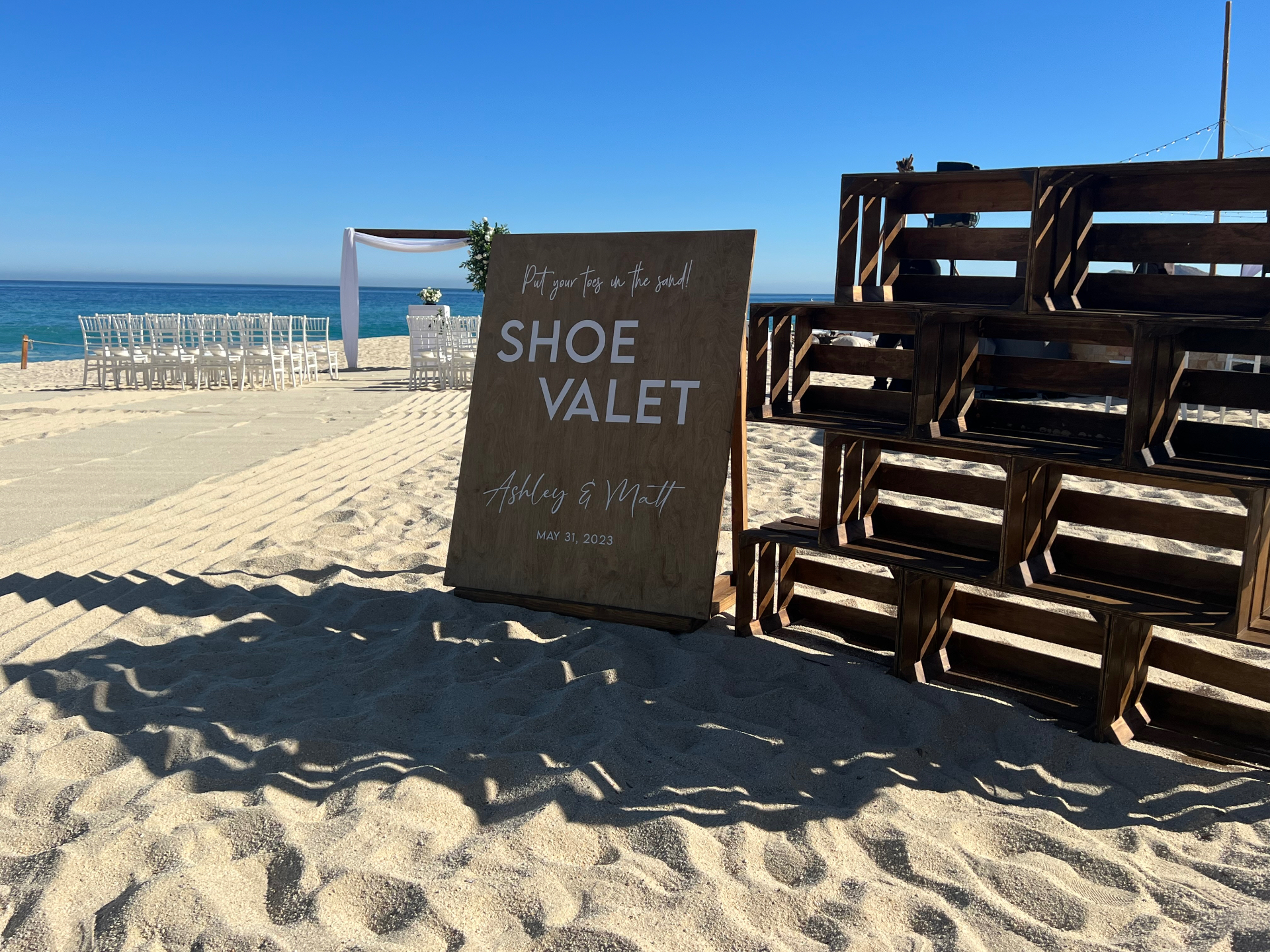 Fun shoe valet sign adding a playful welcome touch to a beachfront wedding event