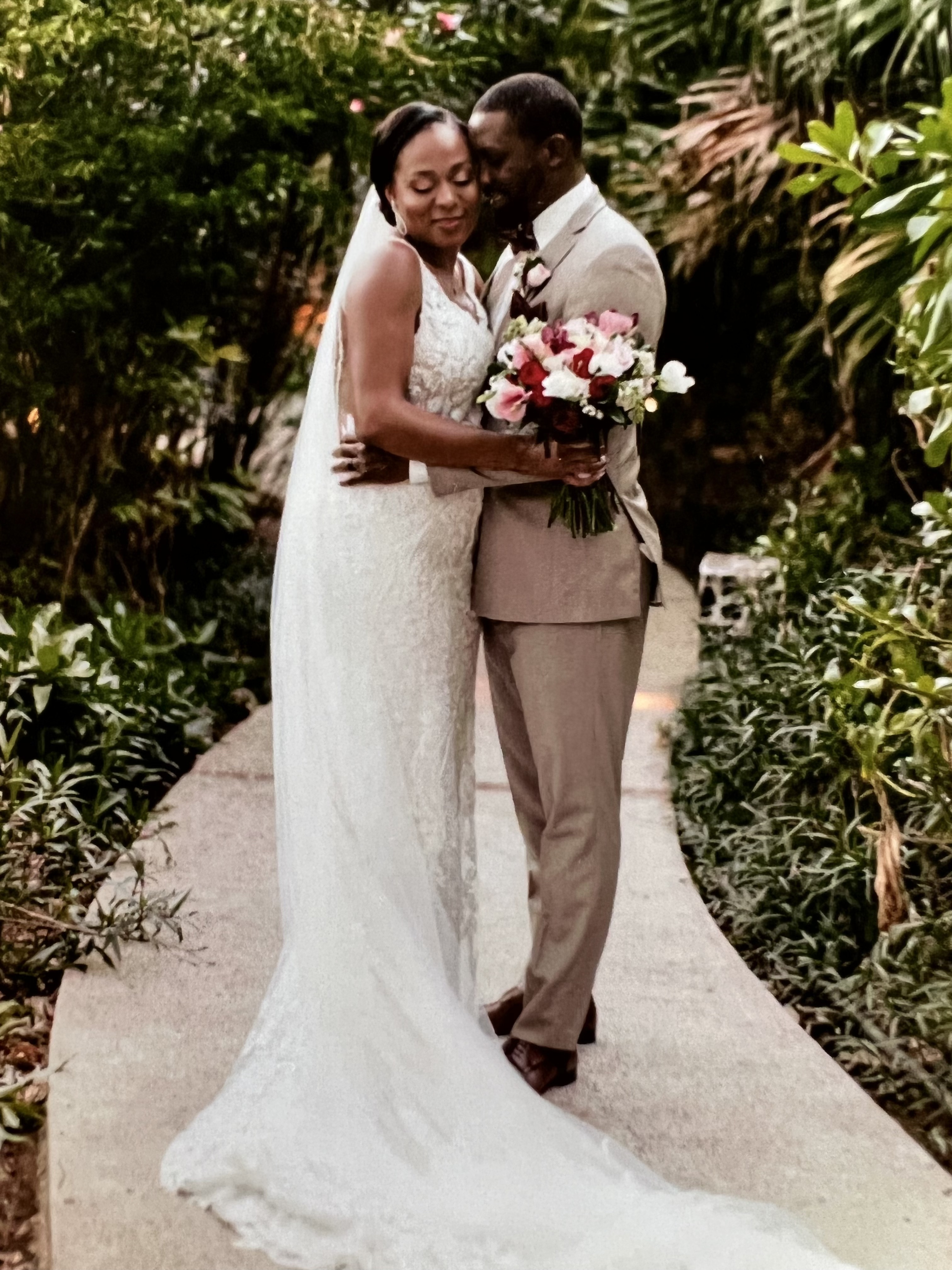 Newly married couple posing on a lush tropical garden path at a destination wedding in Costa Rica