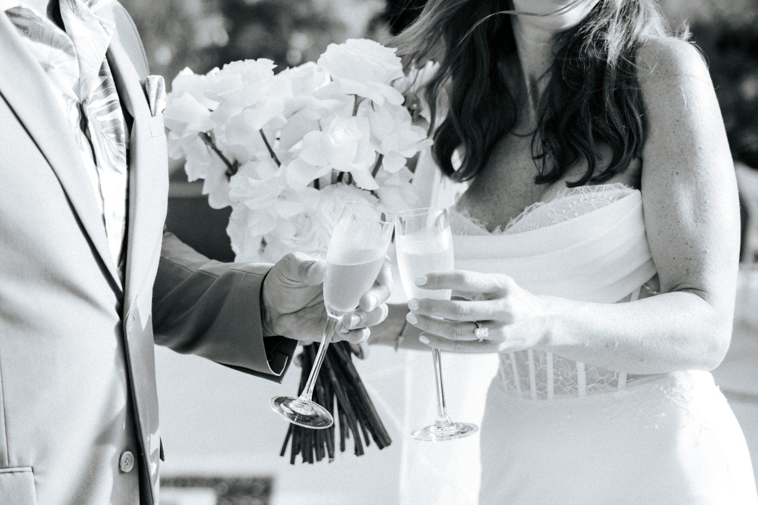 Bride and groom toasting with champagne flutes after their ceremony at Secrets Playa Blanca