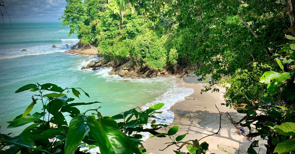 Natural jungle beach in Costa Rica with rocky coastline and turquoise Pacific water