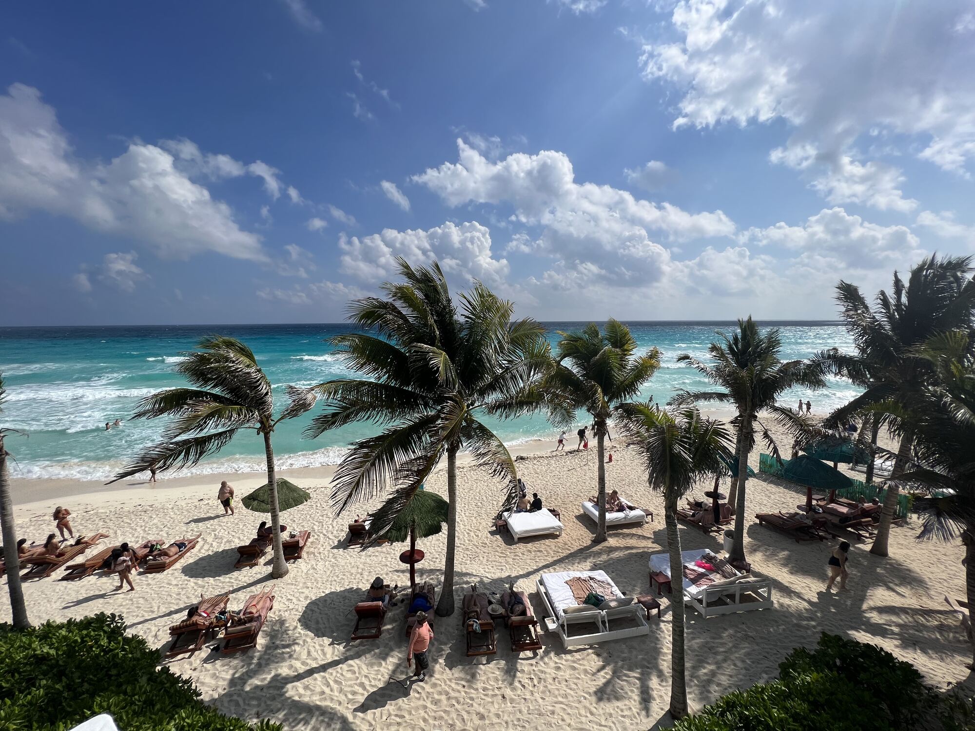 Infinity pool at sunset overlooking the ocean at a tropical destination wedding resort — the postcard image of Caribbean and Mexico dry-season conditions