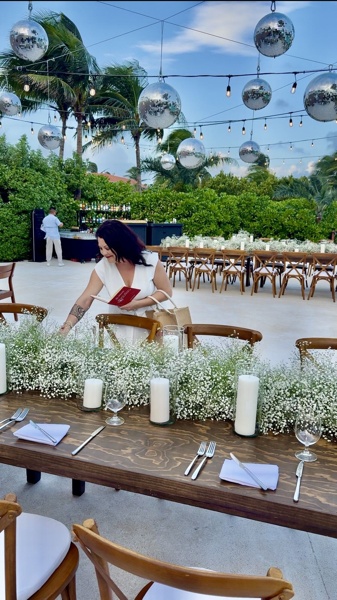 Elegant reception bar cart under a crystal chandelier at a destination wedding resort — the polished, coordinated look couples aim for when planning save-the-dates and invitations