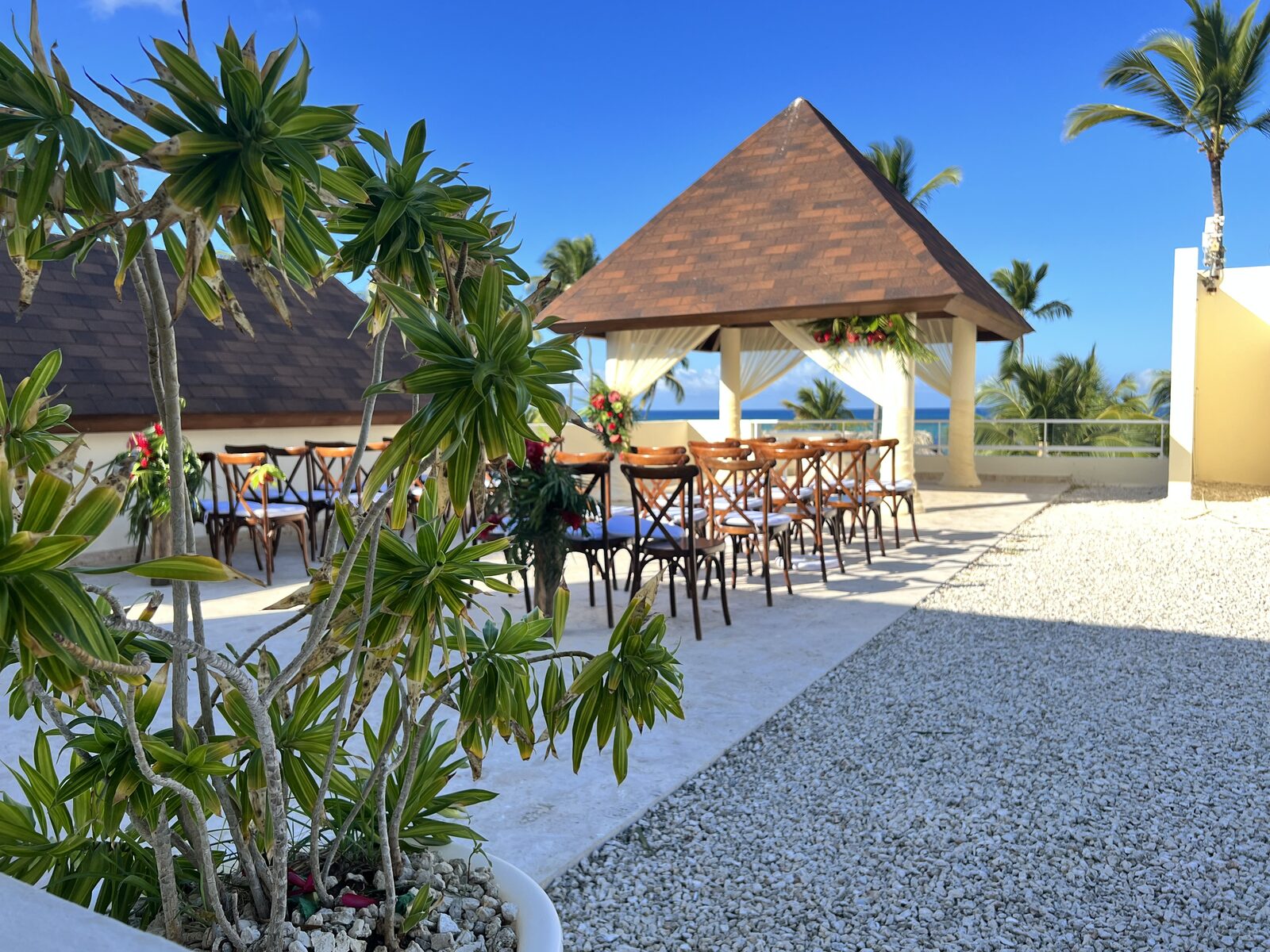 An oceanview pergola ceremony setup with white chairs facing the water, the kind of Riviera Maya wedding venue that gets booked out 12 to 18 months in advance during high season