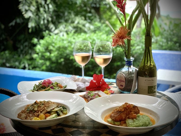 Romantic poolside dinner with wine, tequila, and tropical flowers in Costa Rica
