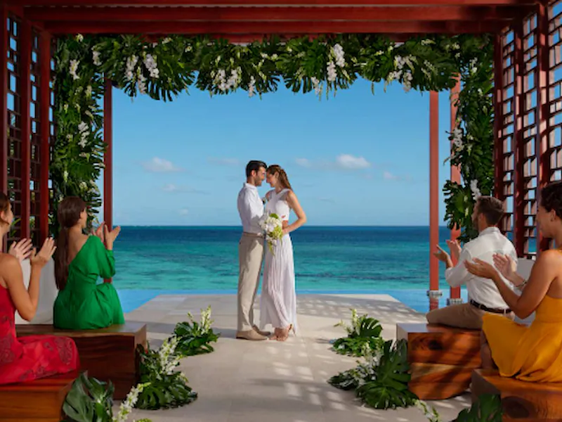 Oceanfront wedding ceremony set up on a wooden pergola deck at Dreams Jade Resort & Spa in the Riviera Maya
