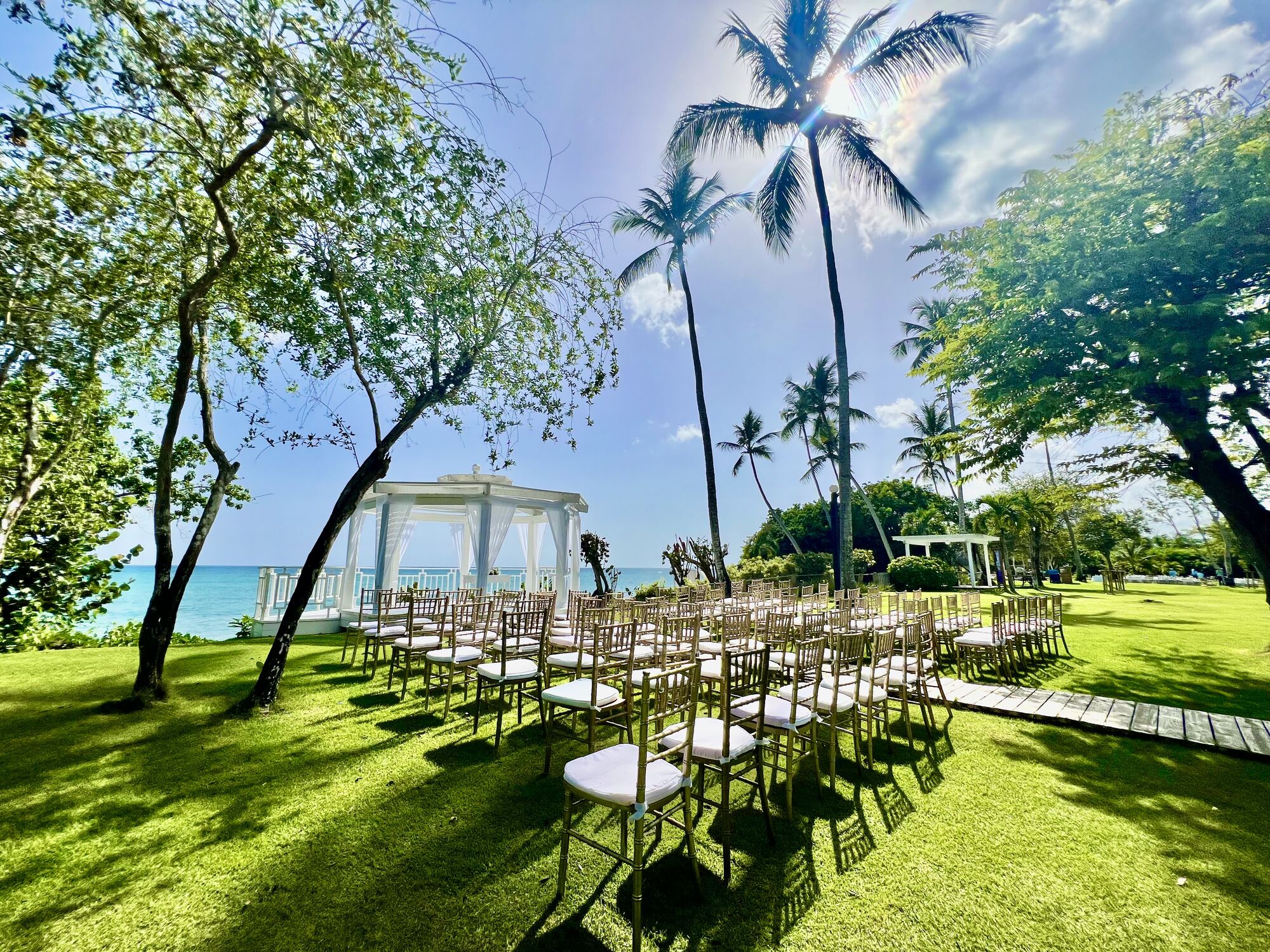 Wedding photographer capturing the vows during an oceanfront ceremony.
